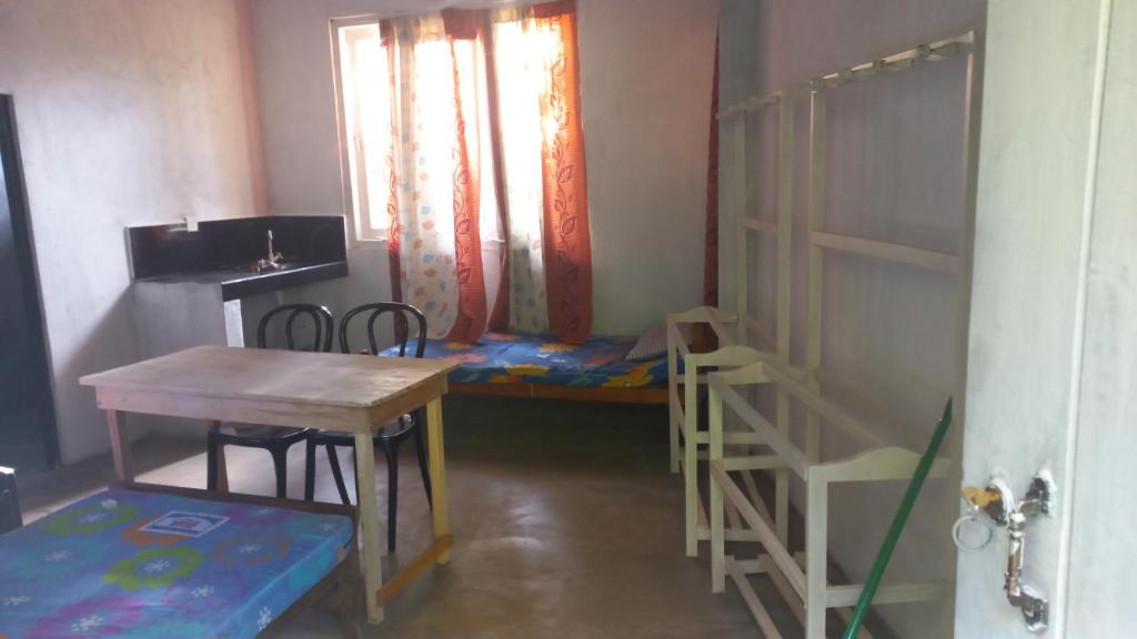 a small room with a table and a bunk bed at HOME bed in Angunawala