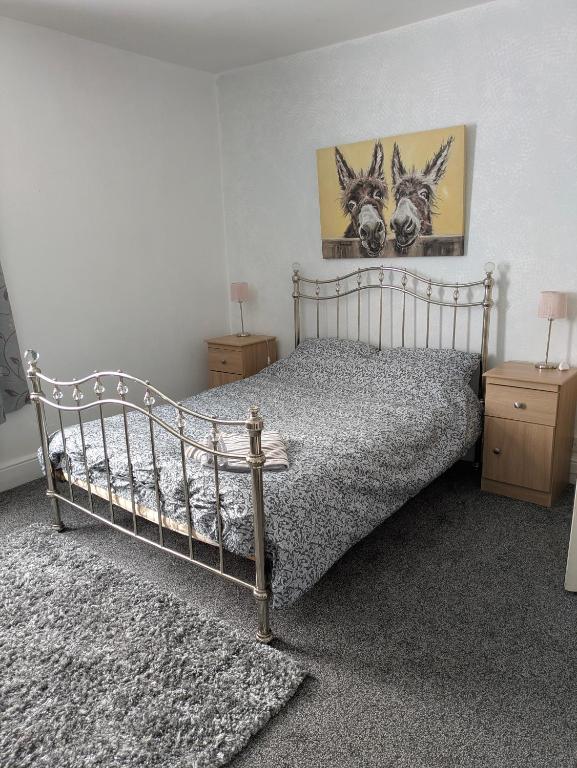 a bedroom with a bed and two night stands at Kettering Town End terrace walking distance to Kettering town in Kettering
