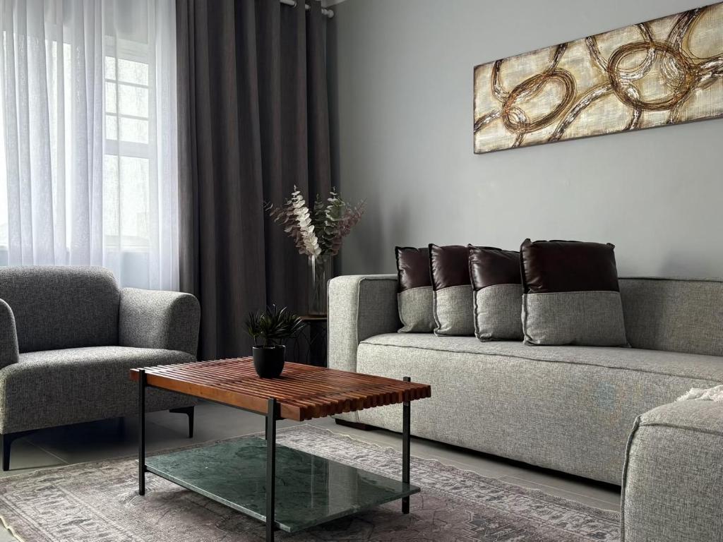a living room with a couch and a coffee table at Windermere Sands in Gqeberha