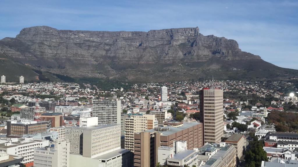 a view of cape town with table mountain in the background at Penthouse Suite at Cartwrights Corner in Cape Town