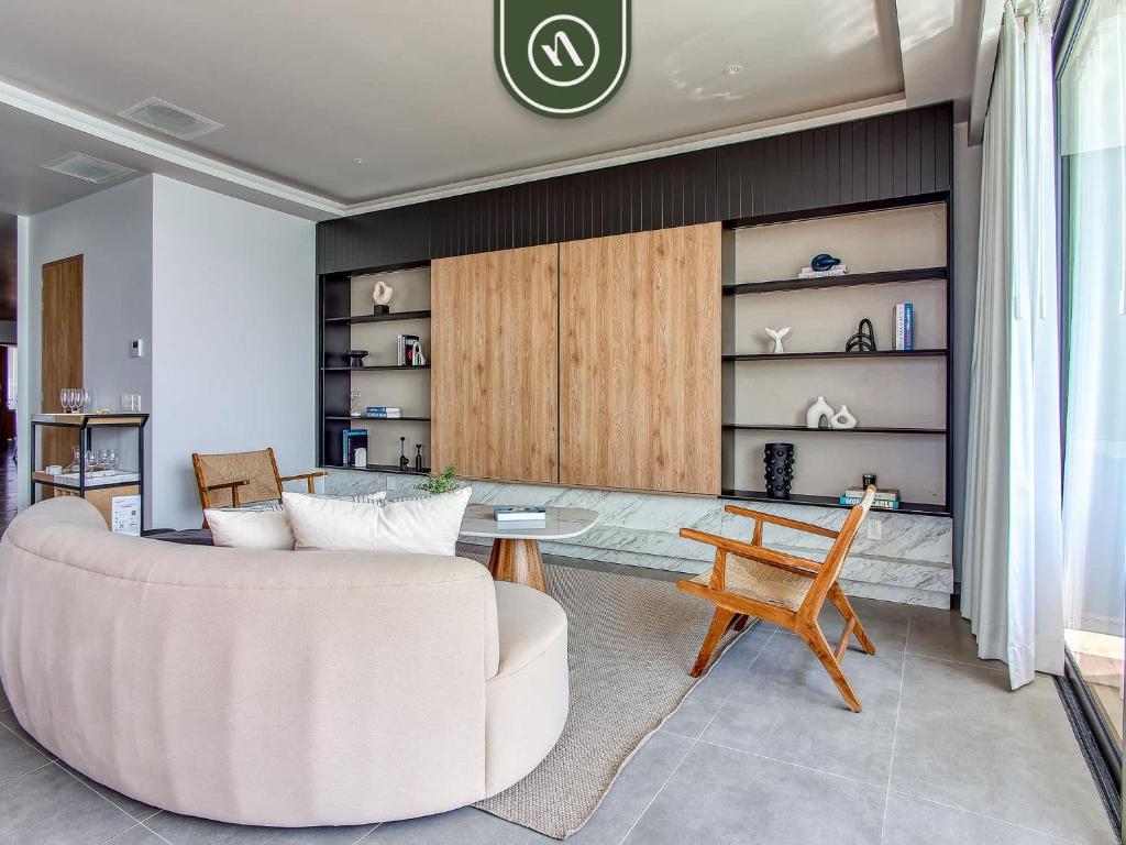 a living room with a white couch and a table at Luxury Oceanfront 3 BR Condo with Balcony in Cruz de Huanacaxtle