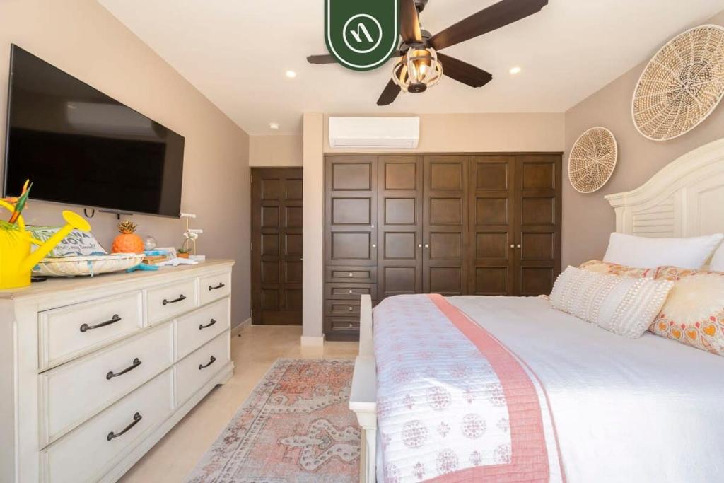 a bedroom with a bed and a flat screen tv at Luxury House with Ocean View in Cabo San Lucas