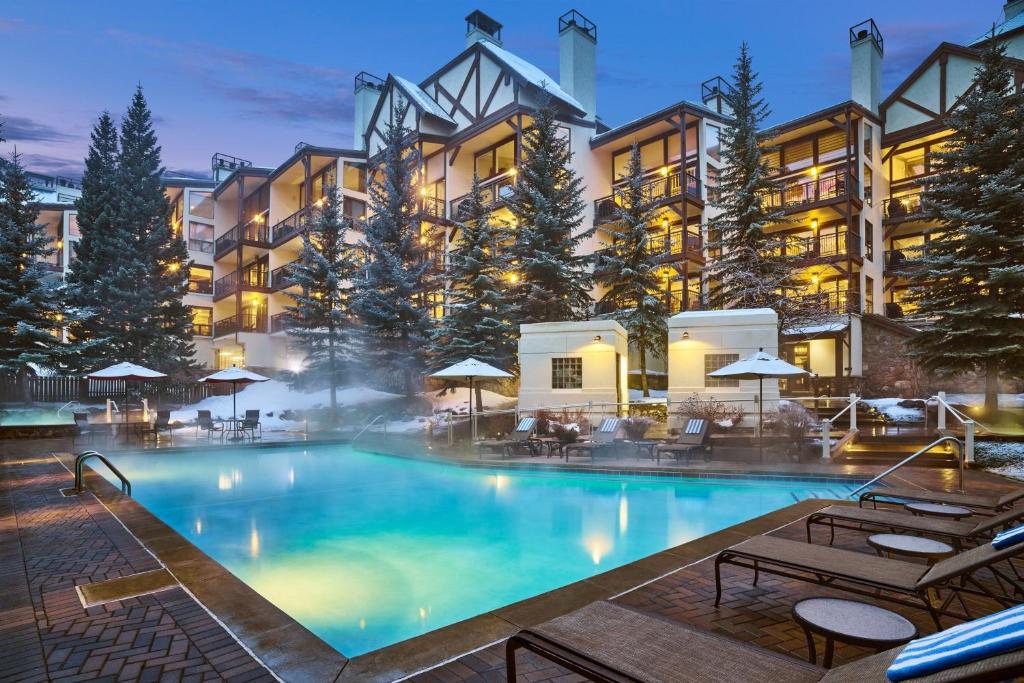a large swimming pool in front of a hotel at Montaneros in Vail in Vail