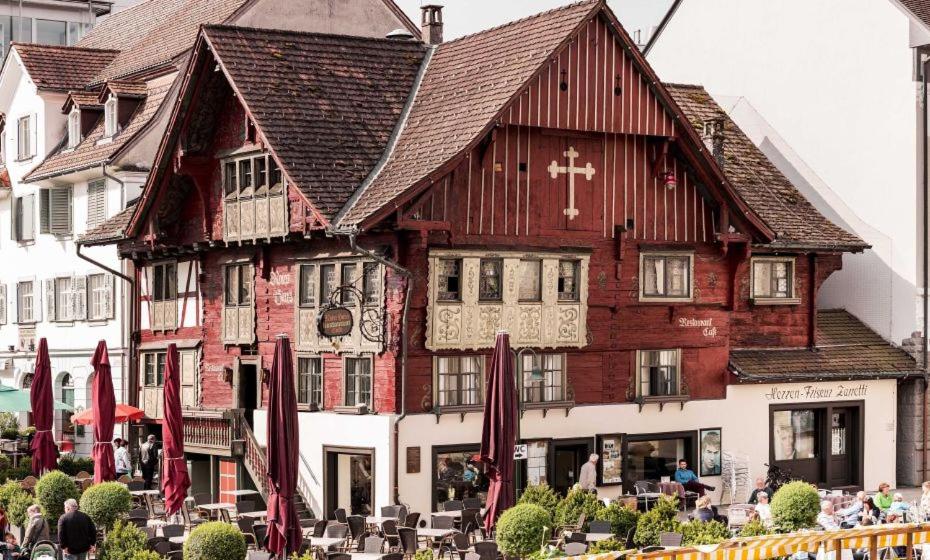 a large wooden building with a cross on it at CrownLiving Babylon Studios in Lustenau