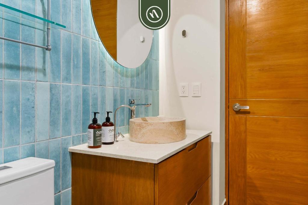 a bathroom with a sink and a toilet and a mirror at New Stylish 1 BR Condo - Ocean Views - Flex Room in Bucerías