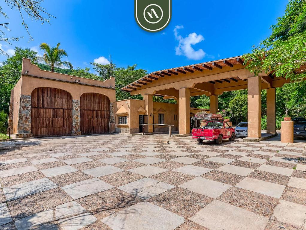 a garage with a red jeep parked in front of it at Luxury Oceanfront Villa - Private Beach - Pool in Chamela