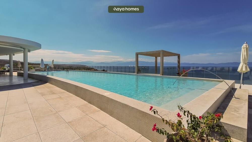 a large swimming pool on top of a building at Amazing Condo - Beach Access - Spa - Pool in Higuera Blanca