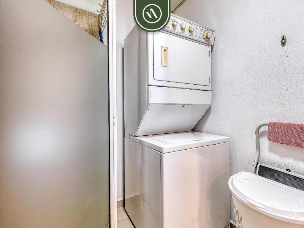 a small bathroom with a washer and dryer at Cozy Beachfront Studio - Beach Club - Pools in Nuevo Nayarit