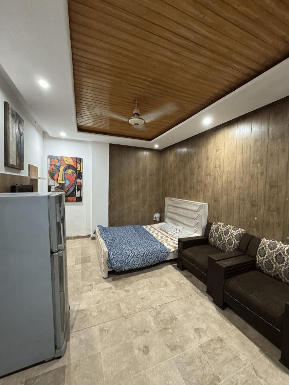 a living room with a couch and a bed at Studio Apartment in Dargai