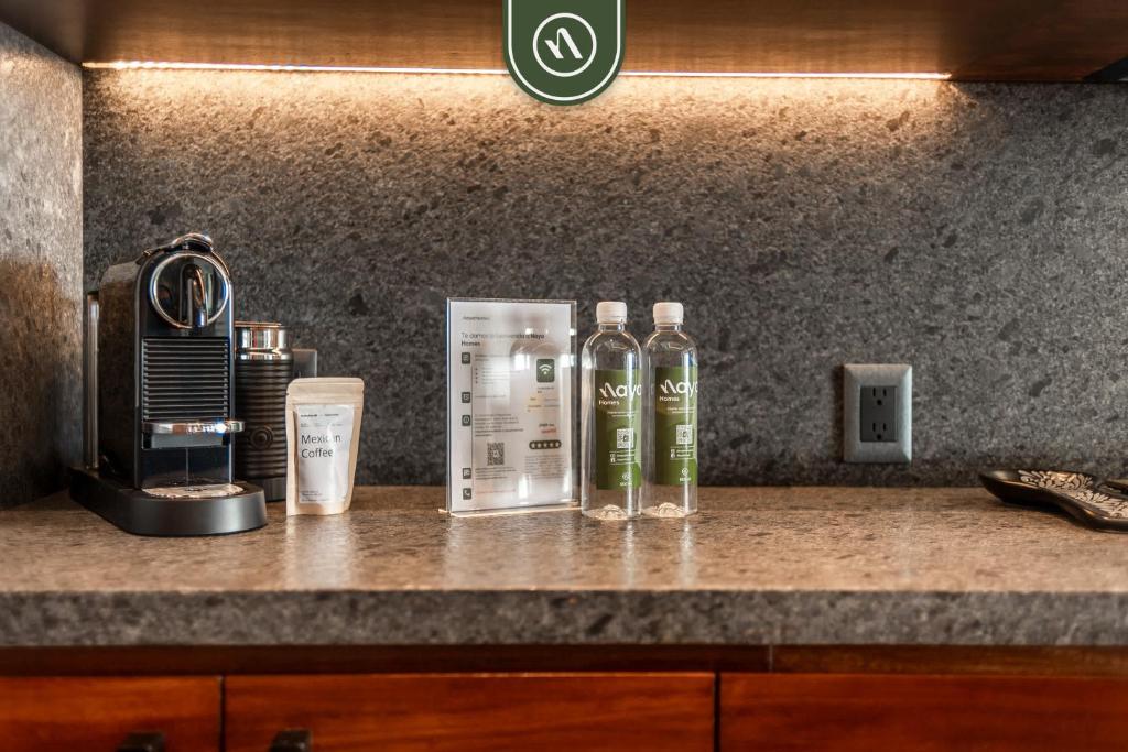 twee flessen alcohol op een aanrecht bij Luxury 2 BR Condo with Beachview - Rooftop Pool in Puerto Vallarta