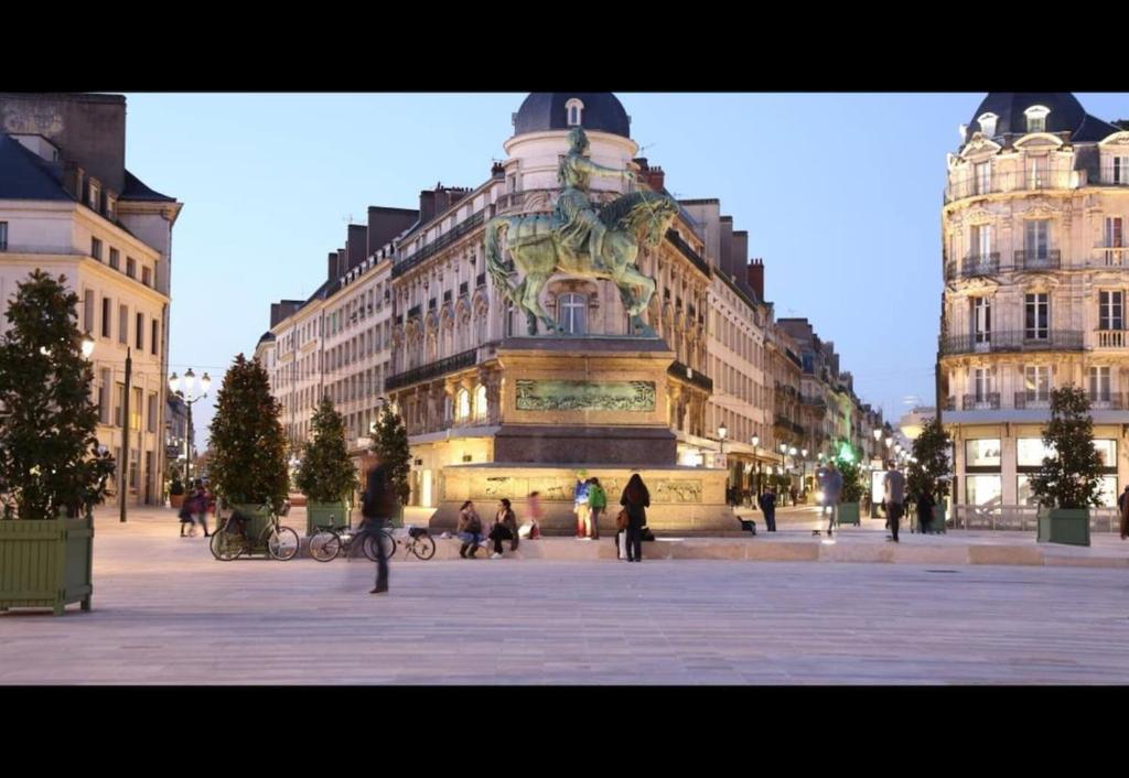 a building with a fountain in the middle of a street at Superbe T2 in Orléans