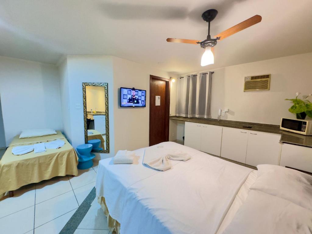 a hospital room with two beds and a ceiling fan at VA Apart Hotel Savassi in Divinópolis
