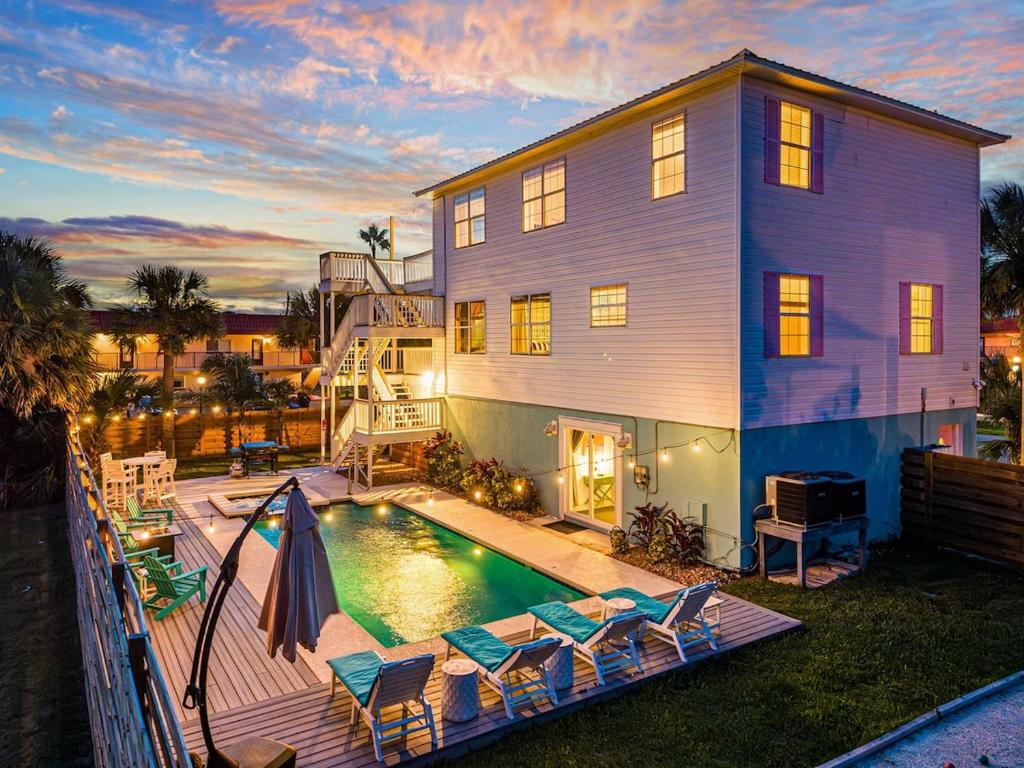a house with a swimming pool in front of a house at HeatedPool HotTub 3min2Beach GameRm PetFriendly in Saint Augustine