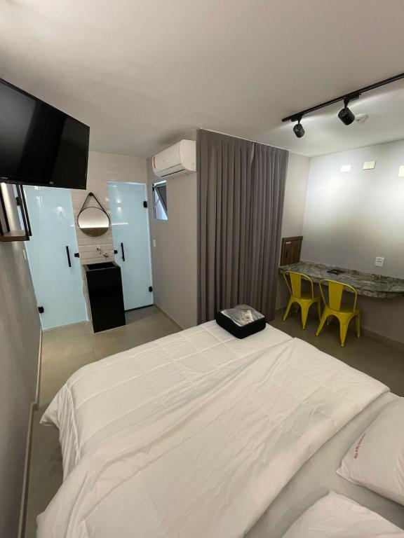 a hotel room with a large bed and a table at Hotel Estrela da Agua Fria in São Paulo