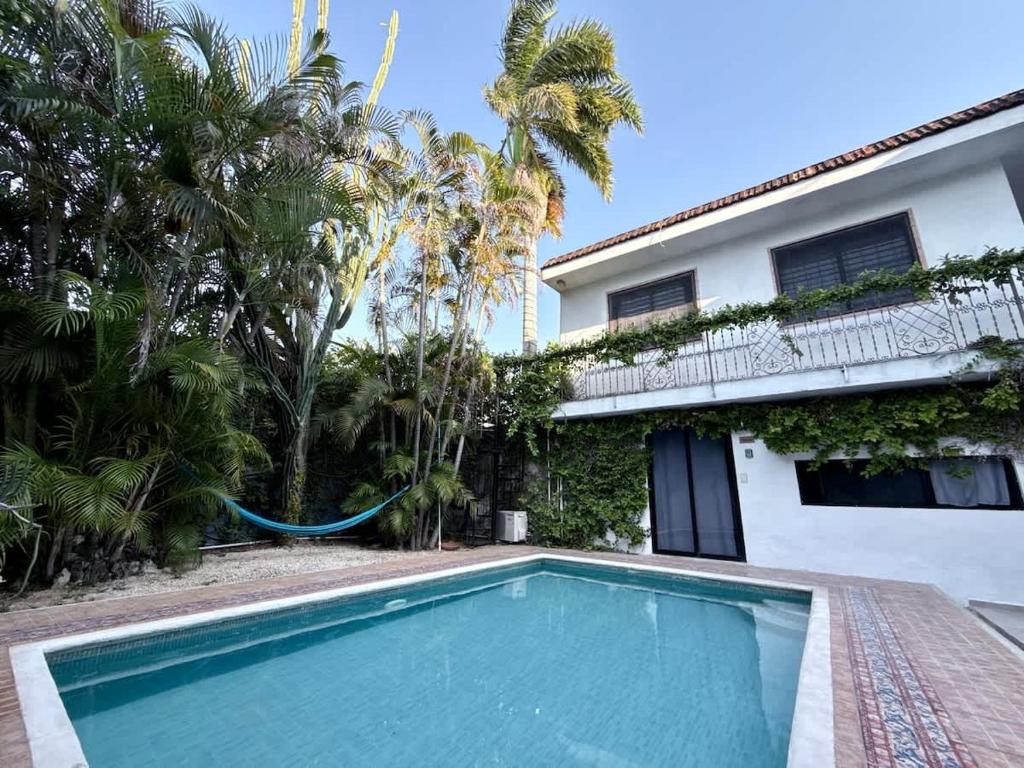 a swimming pool in front of a house at Espacio perfecto para 3 con alberca in Chuburná de Hidalgo
