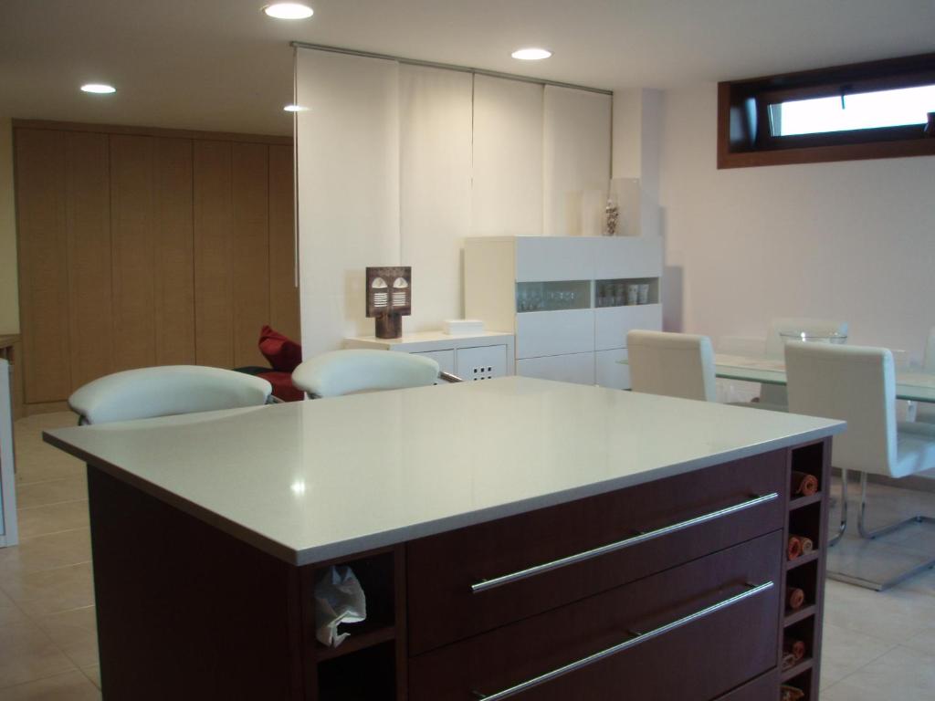 桑克森克索的住宿－Mar y Sol，厨房配有白色的柜台和一些椅子