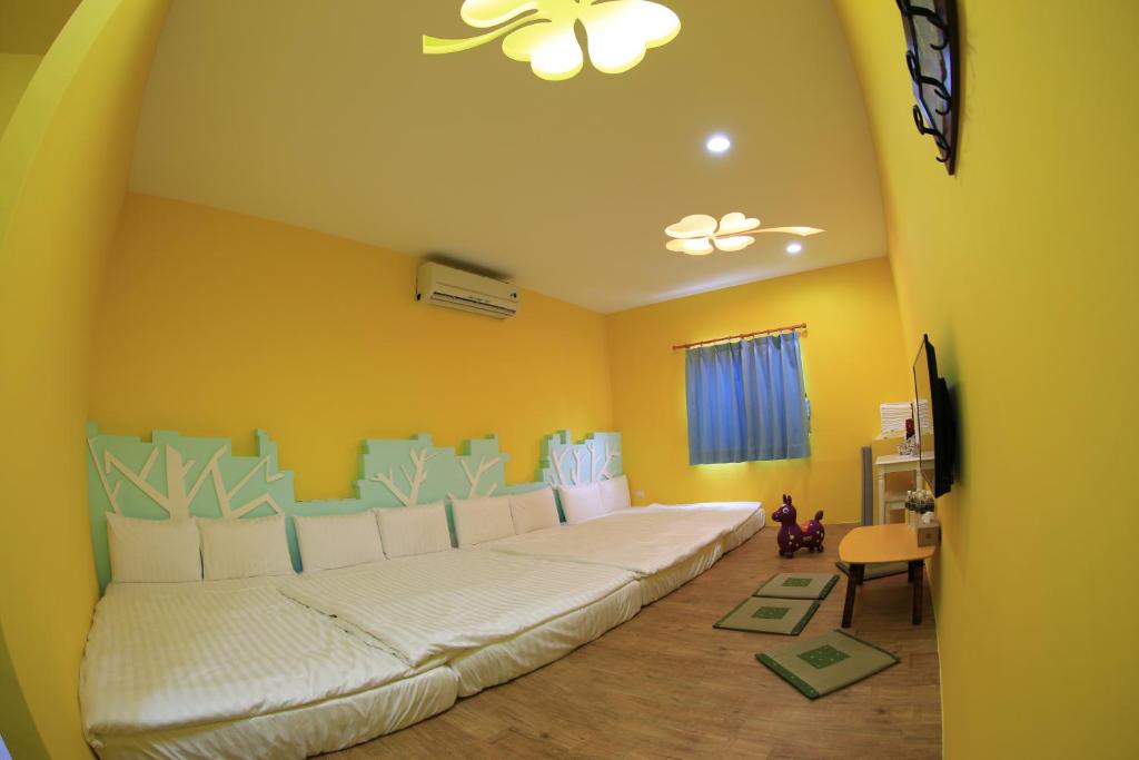 uma sala de estar com um grande sofá branco num quarto em Happy B&B em Xiaoliuqiu