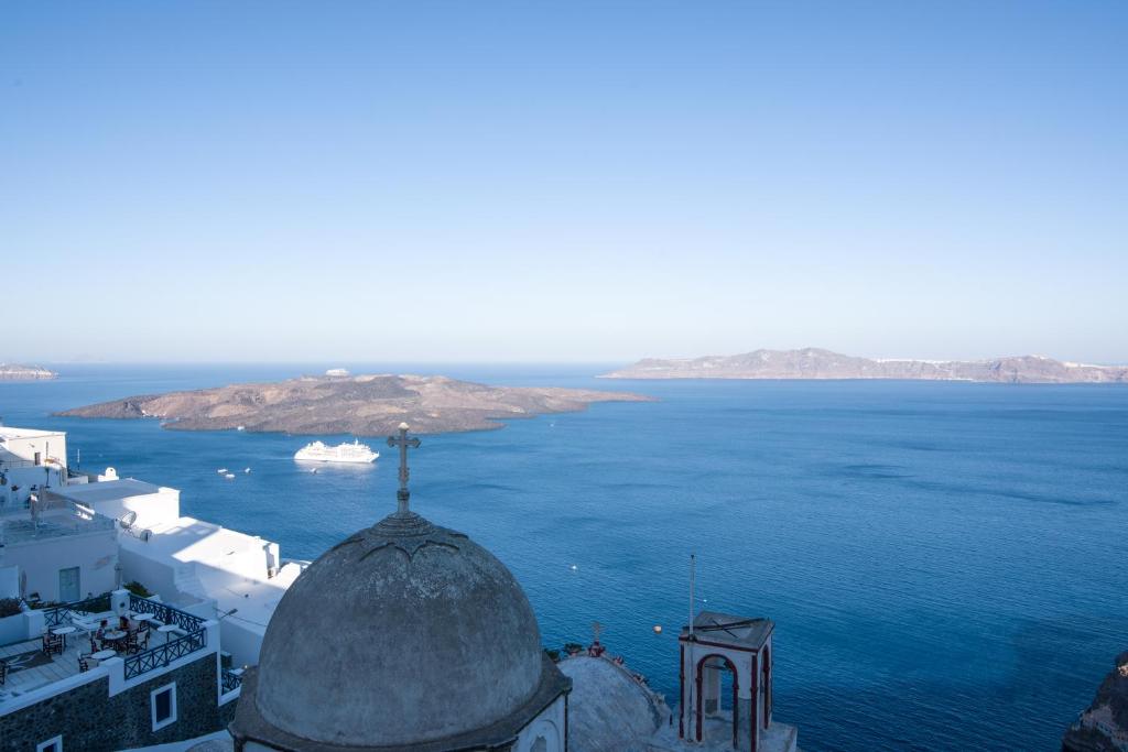 a view of the ocean from the top of a building at Angel Luxury Suites in Fira