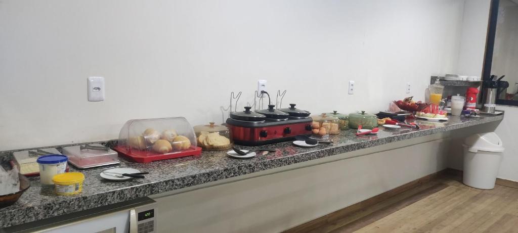 a kitchen counter with a bunch of food on it at Pousada ji Paraná in Ji-Paraná
