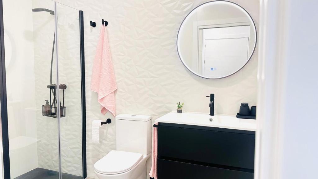 a bathroom with a sink and a mirror at Apartamentos La CárcaVa in Carcaboso