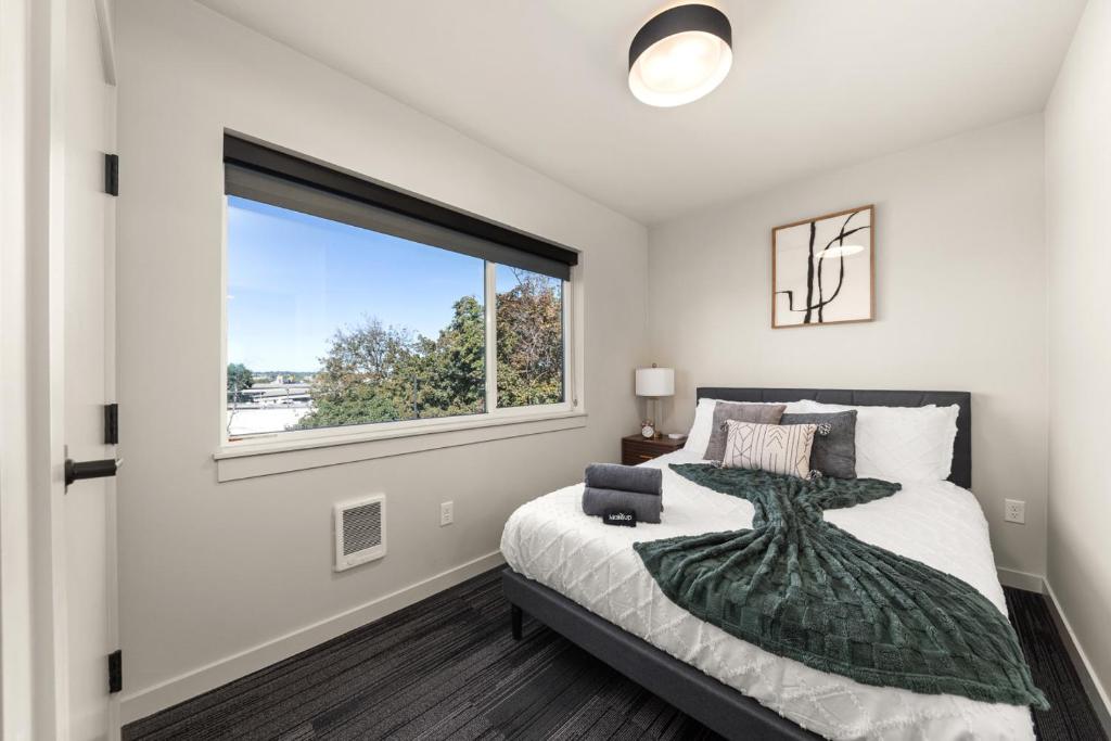 Un dormitorio con una cama y una ventana grande en 2BR Cozy Apartment in DT, en Spokane