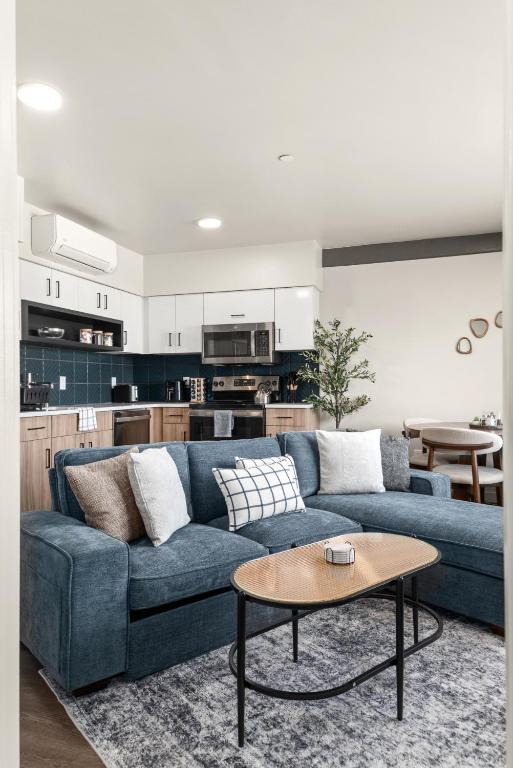 a living room with a blue couch and a table at 2BR Cozy Apartment in DT in Spokane
