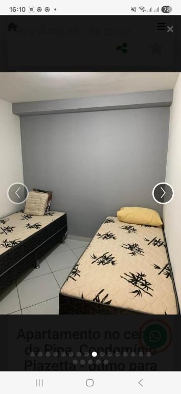 a room with two beds in a room with a keyboard at Hostel Beco da Flor in Pipa
