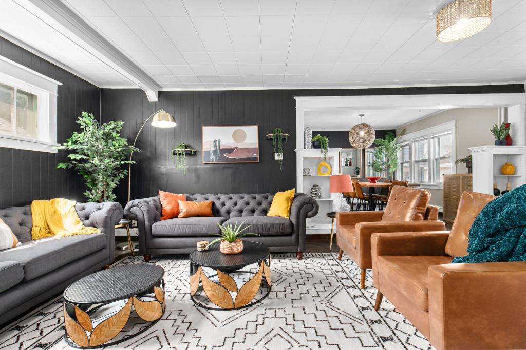 a living room with couches and a dining room at Roomy Central Hub, Games, Fire Pit & Downtown Fun in Oshkosh
