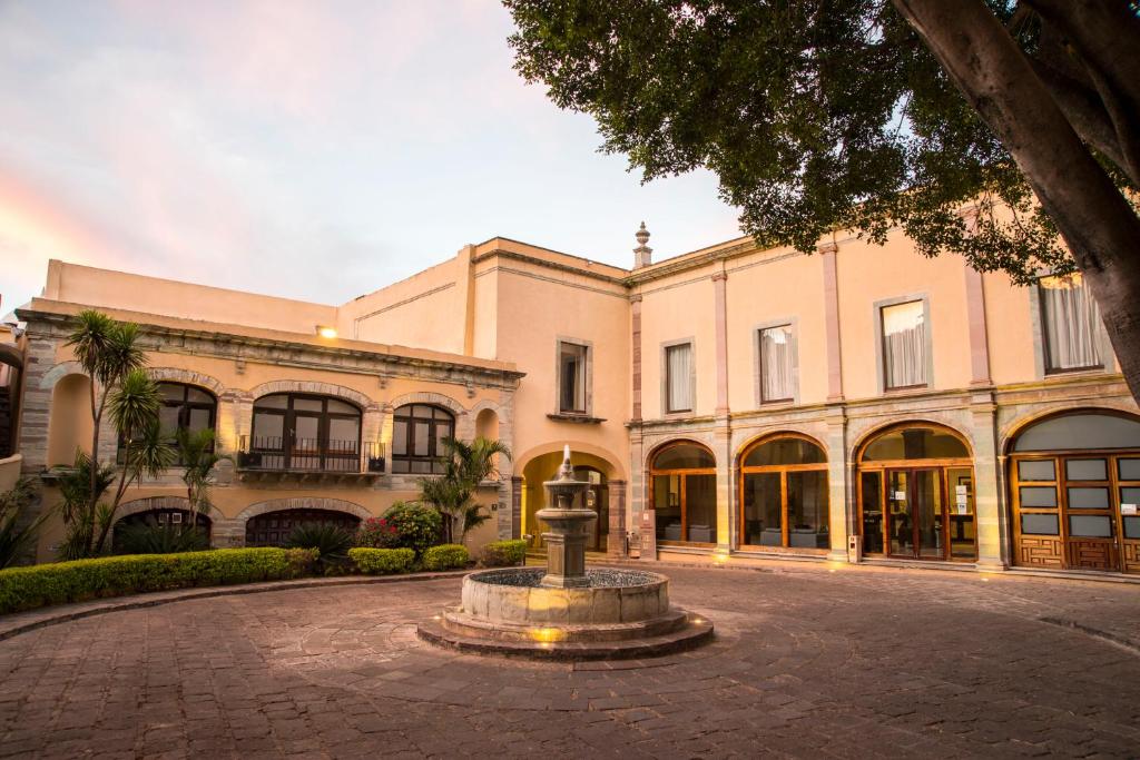 a large building with a fountain in front of it at Hotel Ex-Hacienda San Xavier in Guanajuato