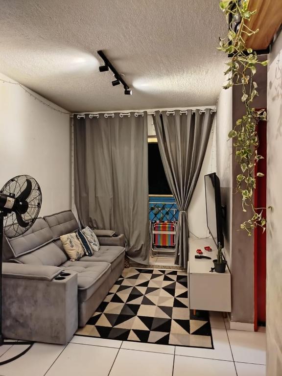 a living room with a couch and a checkered floor at Loft do Bosque in Ananindeua