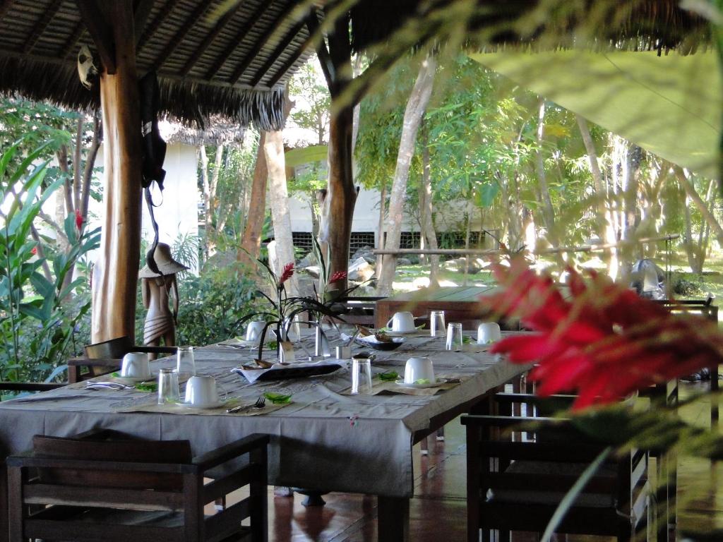 a table in a restaurant with a table set up at Coco Komba Lodge in Nosy Komba