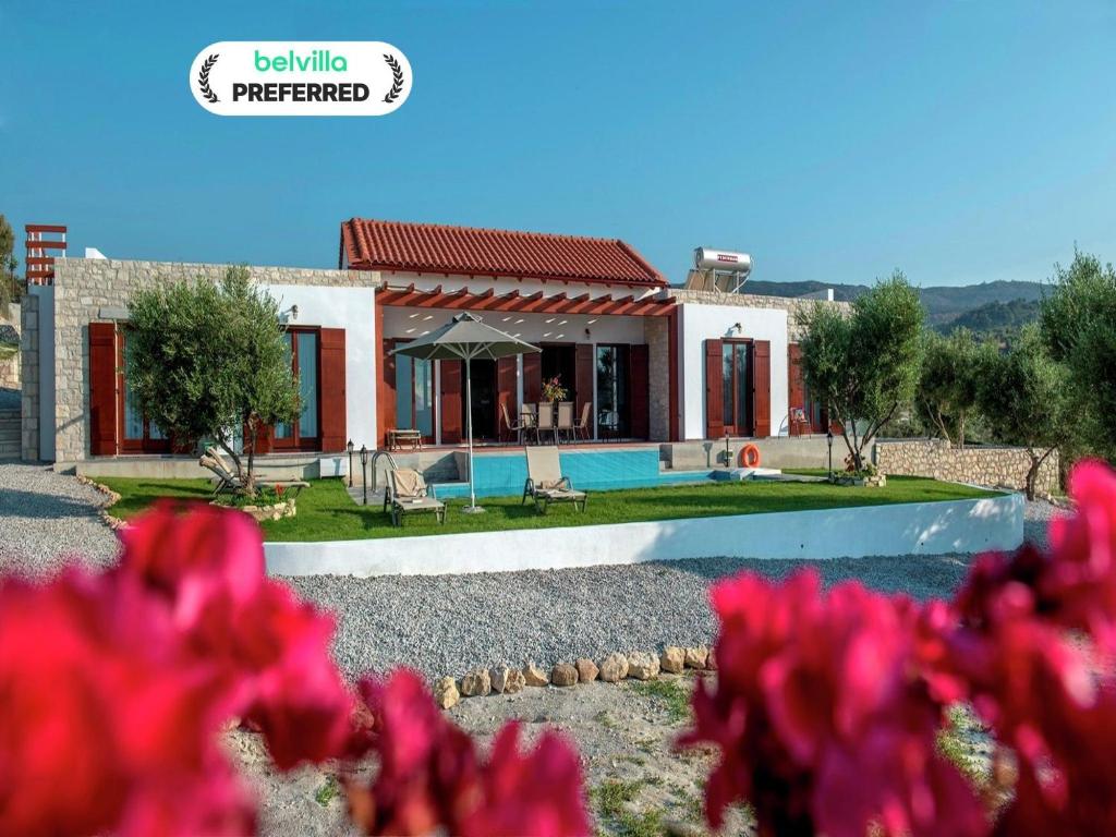 a villa with a swimming pool and a house at Villa in Arkadi with Pool near the Sea in Kiriánna