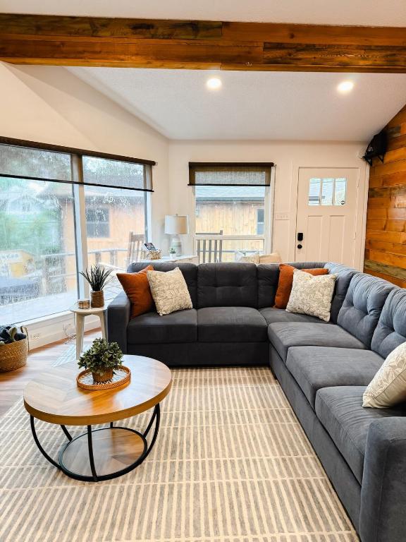 una sala de estar con un sofá y una mesa en Enchanted Oaks Lakehouse, en Enchanted Oaks