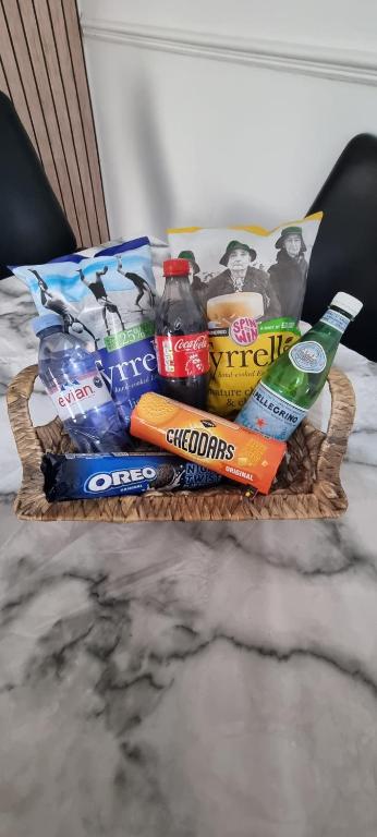 a basket of food and drinks on a bed at Tyne Relaxation in Newcastle upon Tyne