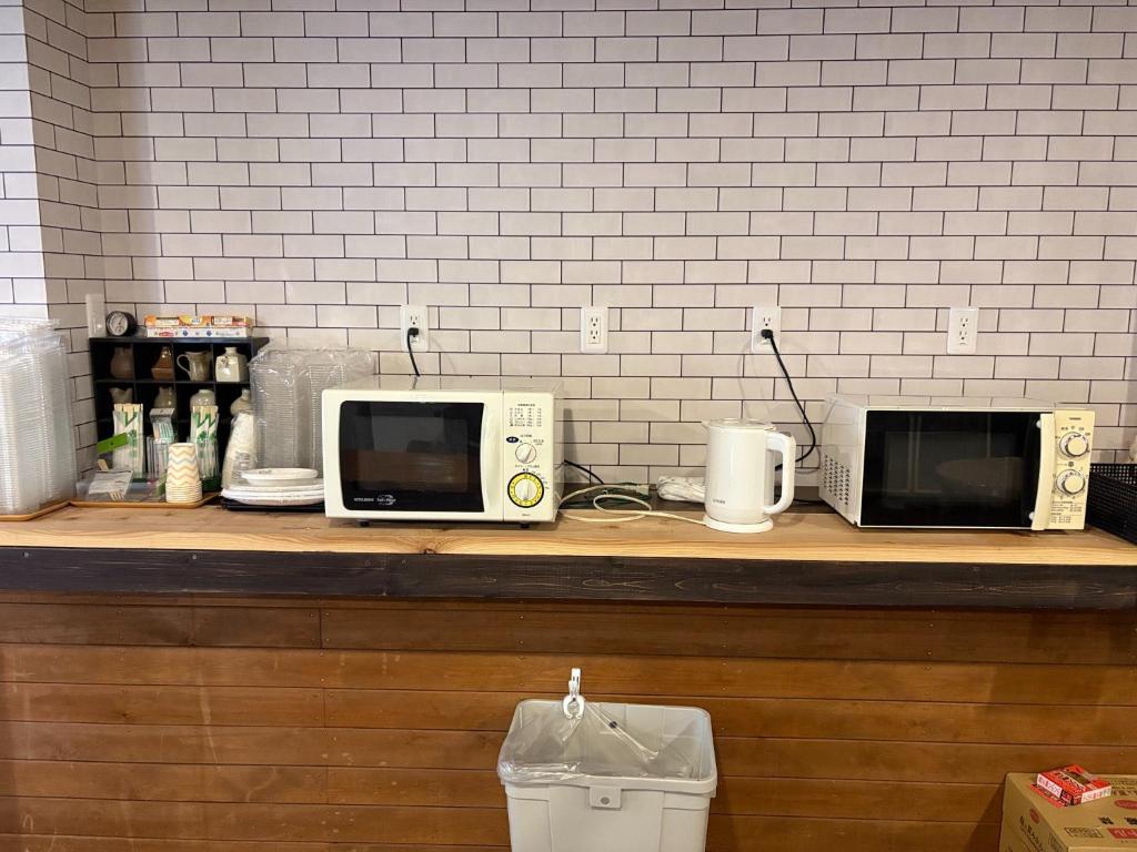 a counter with two microwaves on top of it at Minpaku Gozamisaki - Vacation STAY 23480v in Goza