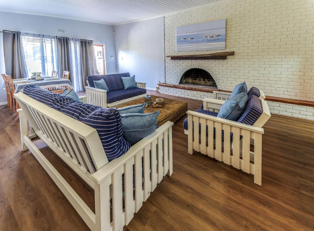 a living room with couches and a fireplace at Southern Right Guest House in Gansbaai