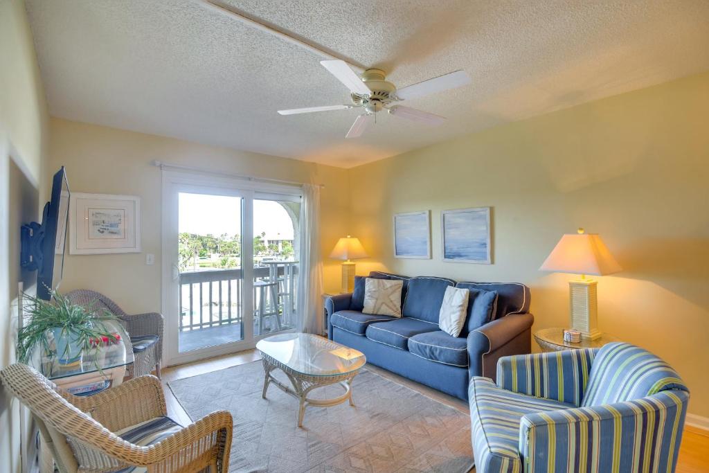 a living room with a blue couch and chairs at Steps to Beach St Augustine Extended Stay Condo! in Coquina Gables