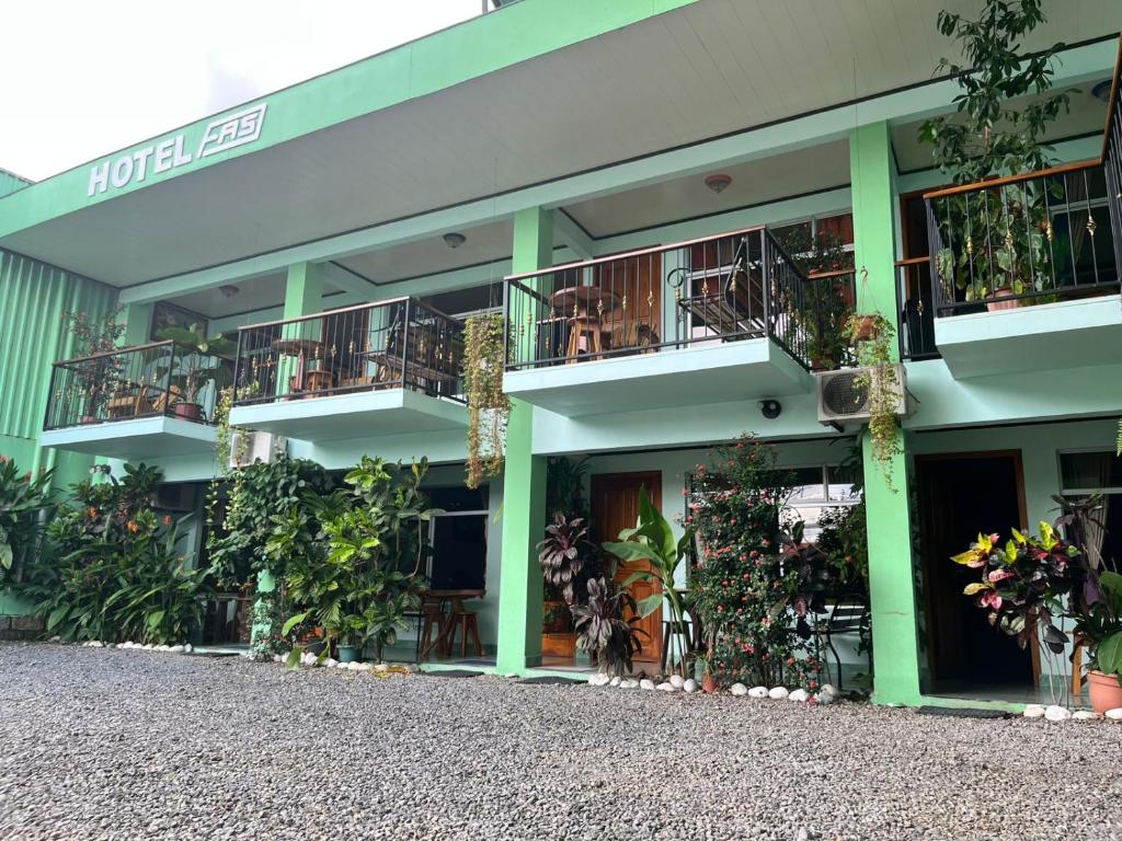 a building with balconies and tables and plants at Hotel FAS in Fortuna