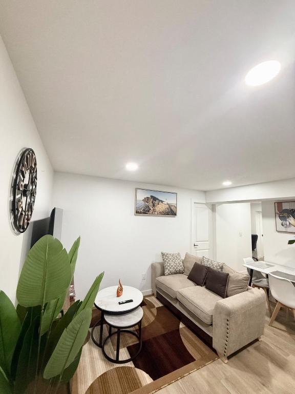 a living room with a couch and a table at Cozy 2 Bedroom Suite Close to Amenities in Edmonton