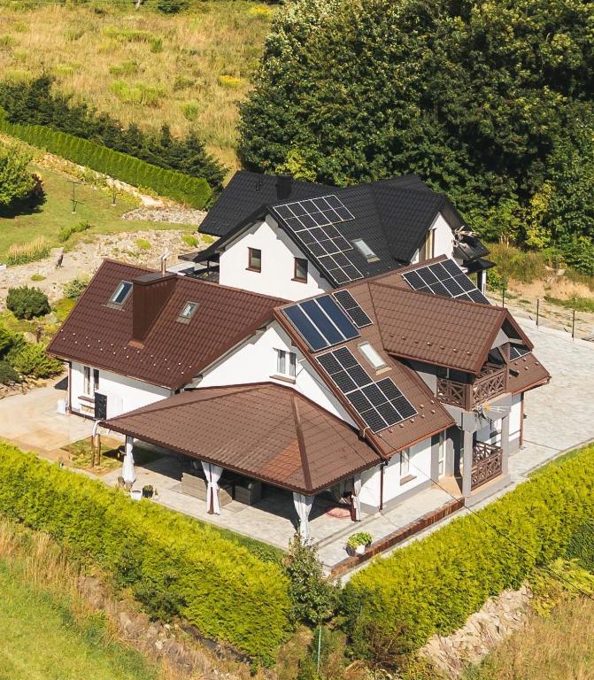 an aerial view of a house with solar panels on it at Dom w Chomranicach-domek grillowy in Chomranice