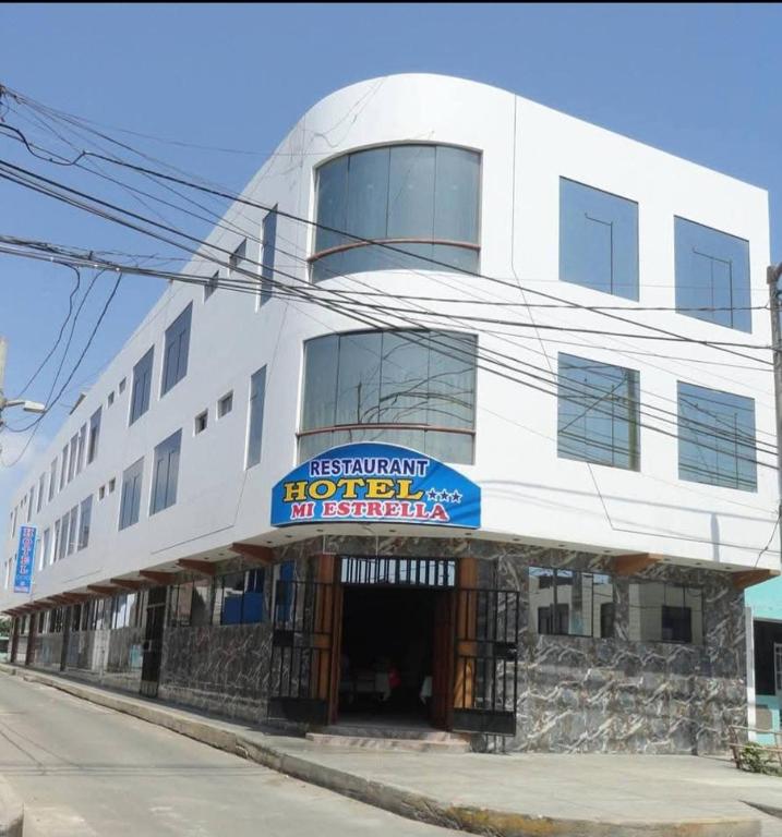 a white building with a sign for a hotel at Hotel Mi Estrella in Chimbote