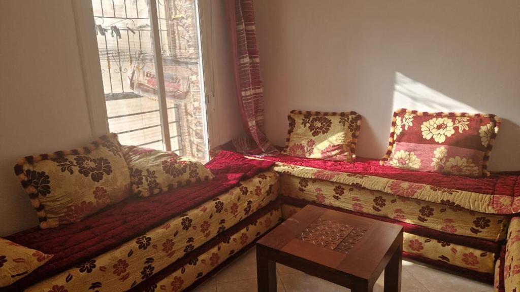 a living room with a couch and a window at Appart hôtel tanger in Tangier