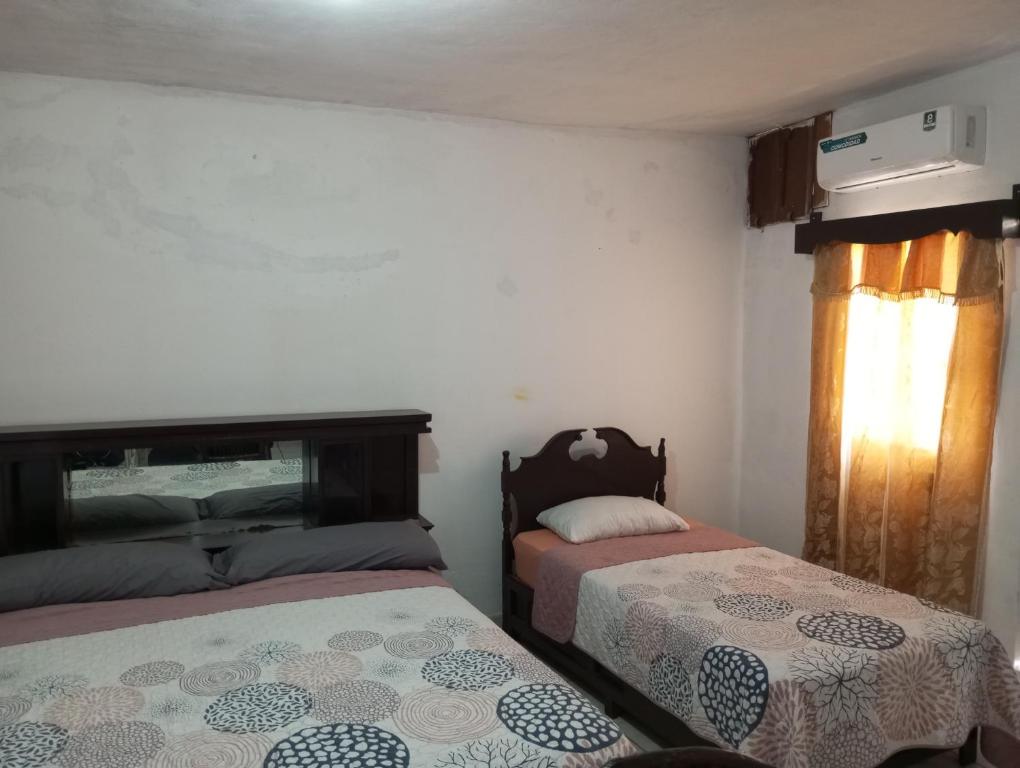 a bedroom with two beds and a window at Mini Departamento a 5 minutos de la Playa! in Mazatlán