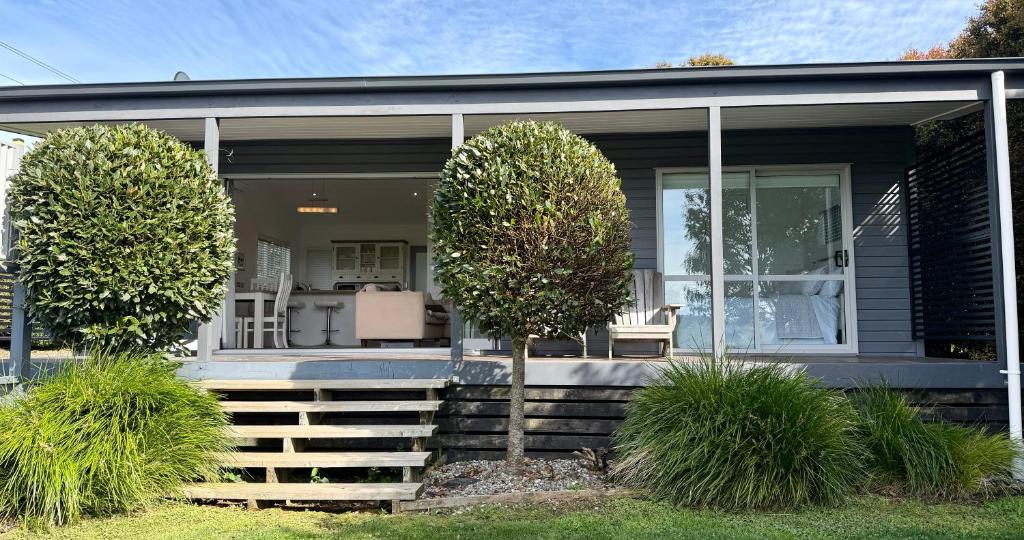a house with two trees in front of it at Hideaway Cottage, Tauranga, so close to Bethlehem & Mount Manganui in Tauranga