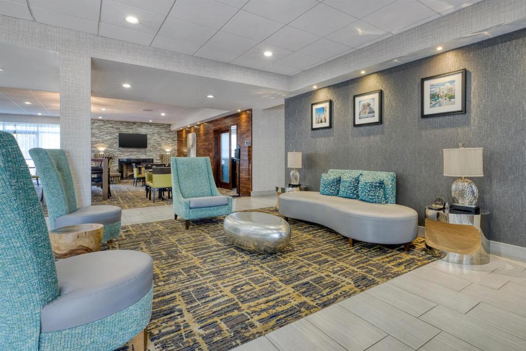 a waiting room with blue chairs and a couch at Best Western Fishers Indianapolis Area in Fishers