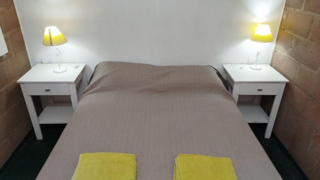 a bedroom with two nightstands and a bed with two lamps at Monoambiente Para 2 in Belén