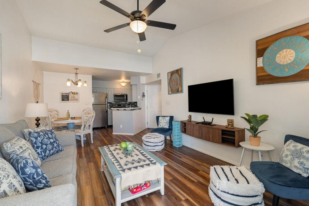 a living room with a couch and a flat screen tv at Serene Zen King Bed Condo - Half Mile from Beach in Melbourne