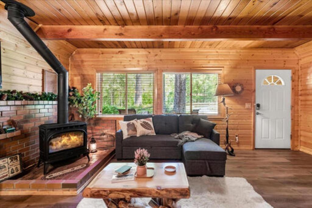 a living room with a couch and a fireplace at Antler House in Ashford
