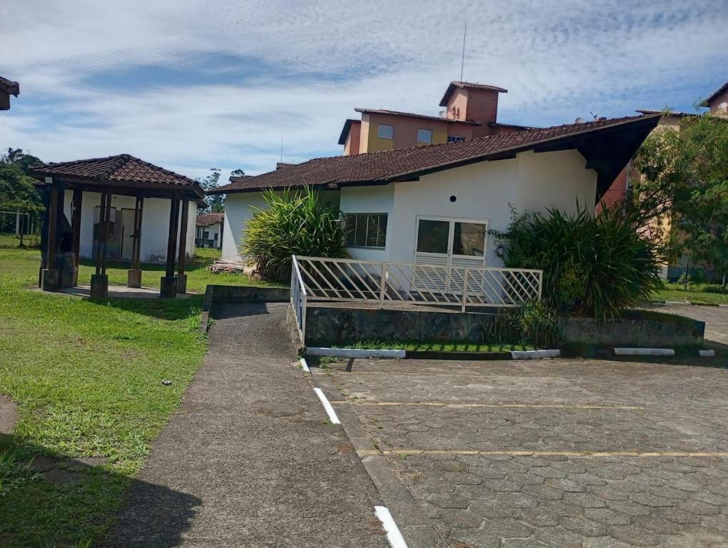 a house with a bench in front of it at Apartmento Itanhaem in Itanhaém