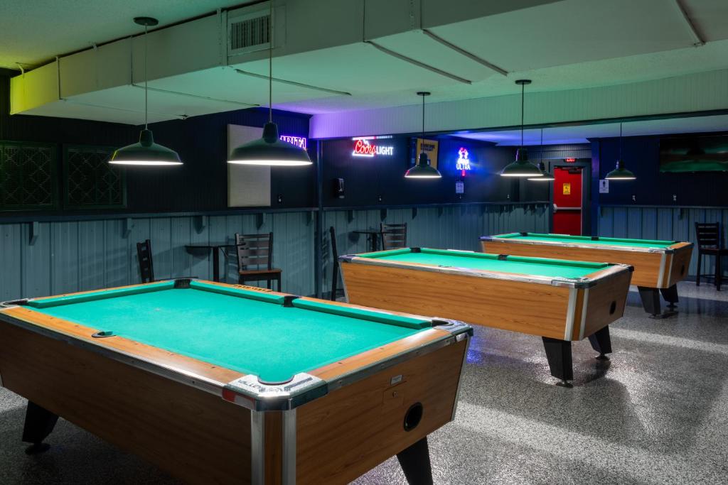 two pool tables in a room with lights at Budget Inn & Suites Baton Rouge in Baton Rouge